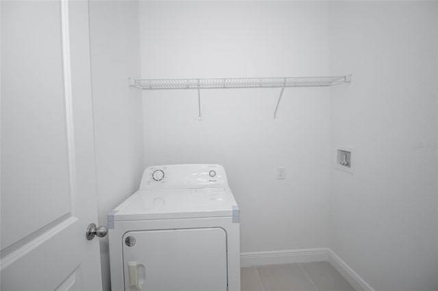 laundry area featuring washer / dryer and light tile patterned flooring