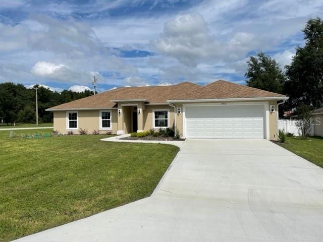 ranch-style home with a front lawn and a garage