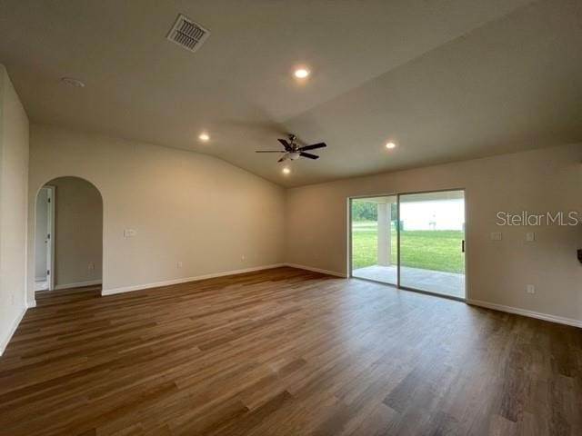 unfurnished room with lofted ceiling, dark hardwood / wood-style floors, and ceiling fan