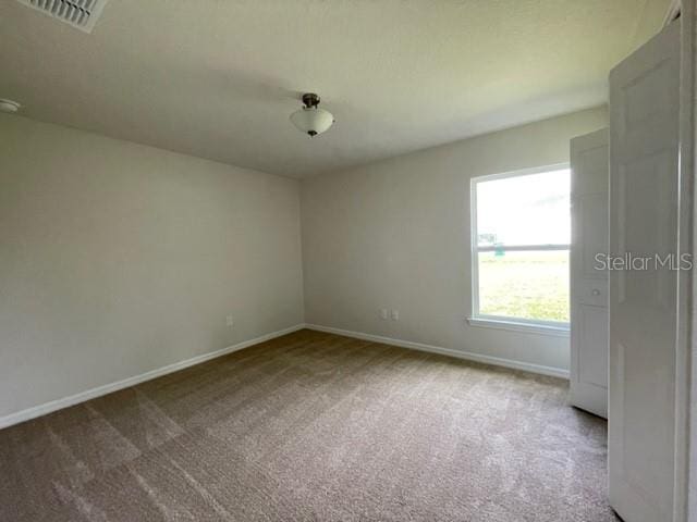 empty room with light colored carpet