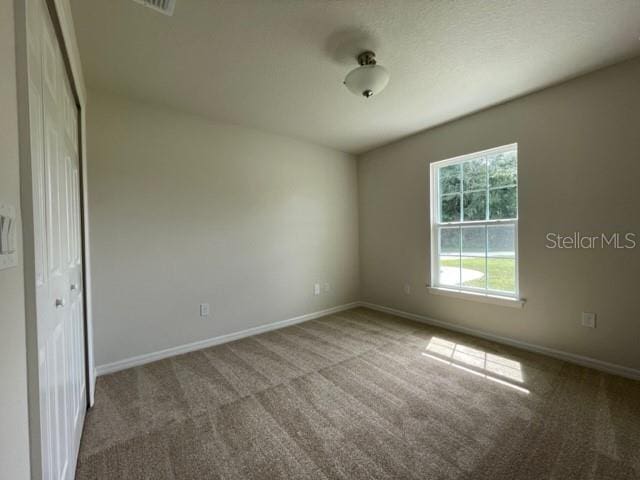 unfurnished room featuring carpet