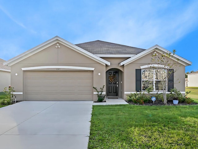 single story home with a front yard and a garage