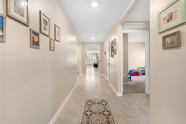 hall featuring light tile patterned floors