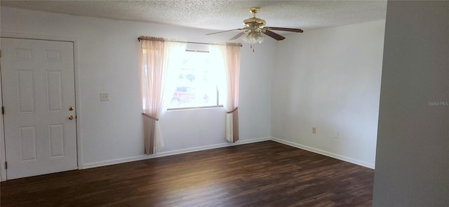 empty room featuring a textured ceiling, ceiling fan, and dark wood-type flooring