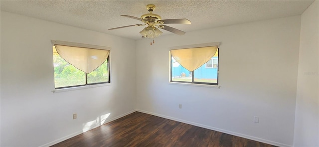 empty room with a textured ceiling, dark hardwood / wood-style flooring, and ceiling fan