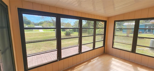 unfurnished sunroom featuring a healthy amount of sunlight and lofted ceiling