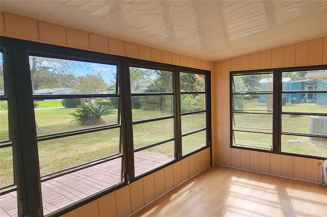 unfurnished sunroom featuring vaulted ceiling and a wealth of natural light