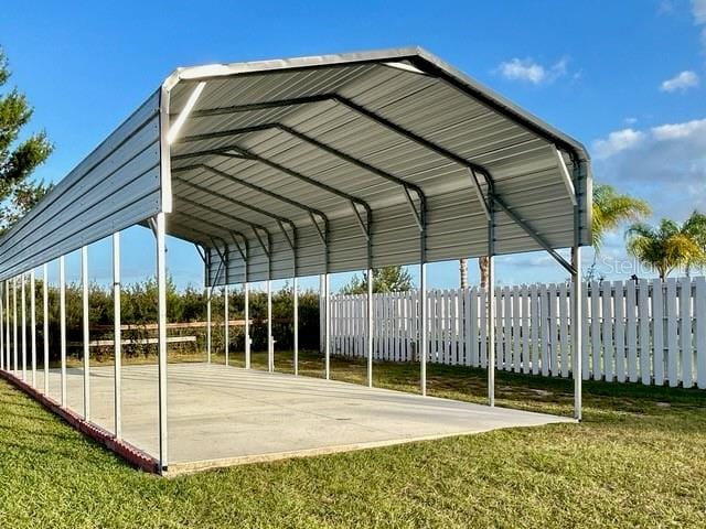 view of car parking featuring a yard and a carport