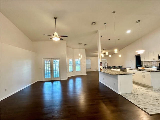 kitchen featuring white cabinetry, french doors, sink, dark hardwood / wood-style floors, and pendant lighting