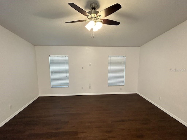 spare room featuring dark hardwood / wood-style floors and ceiling fan