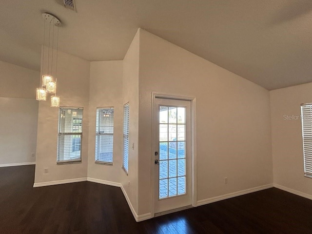 interior space featuring dark wood-type flooring and a chandelier