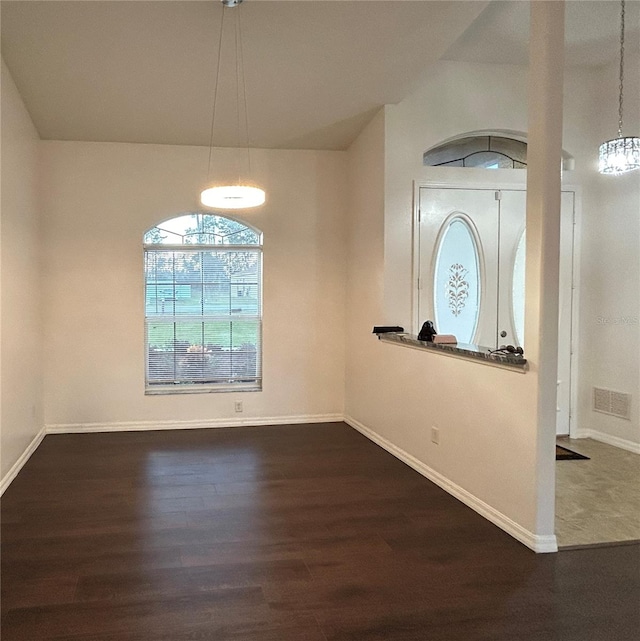 interior space with dark hardwood / wood-style flooring and an inviting chandelier