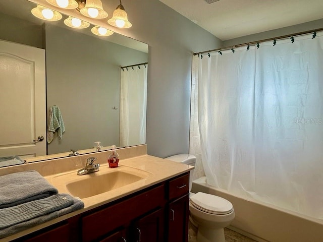 full bathroom with vanity, shower / tub combo, and toilet