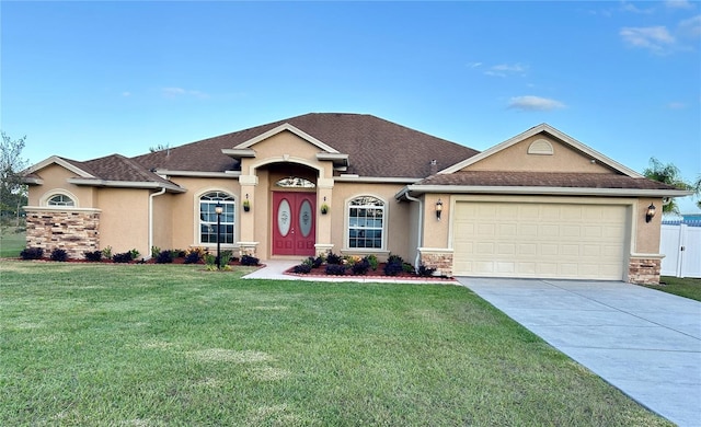 view of front of property with a front yard and a garage