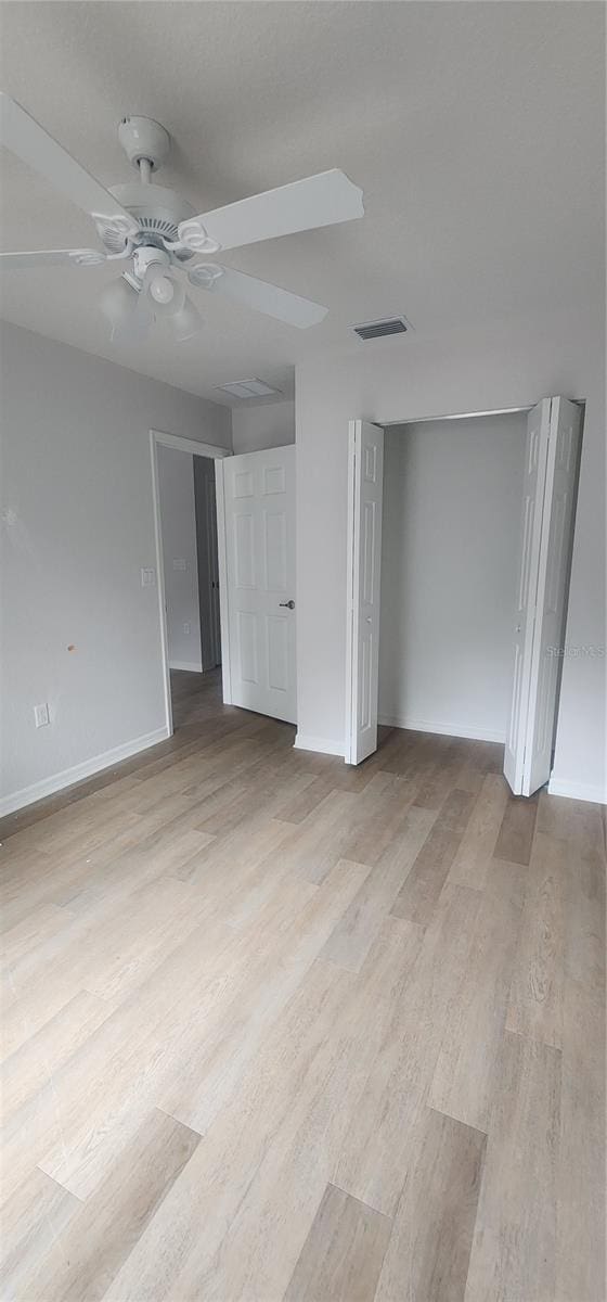 interior space with ceiling fan and light hardwood / wood-style floors