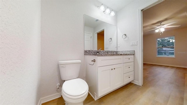 bathroom with ceiling fan, vanity, toilet, and hardwood / wood-style floors