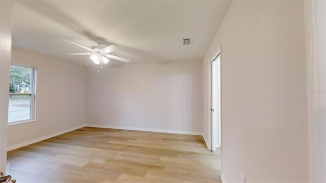 empty room with ceiling fan and light hardwood / wood-style flooring