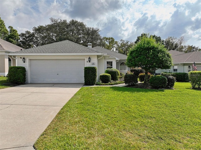 single story home featuring a front lawn and a garage