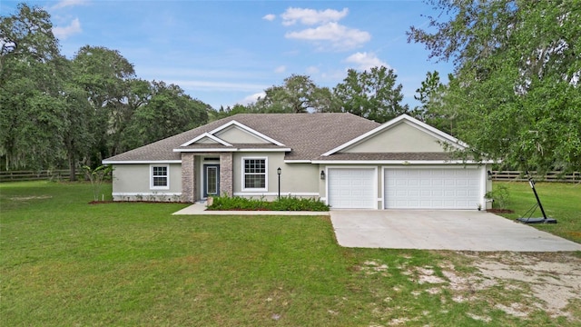 single story home featuring a garage and a front yard