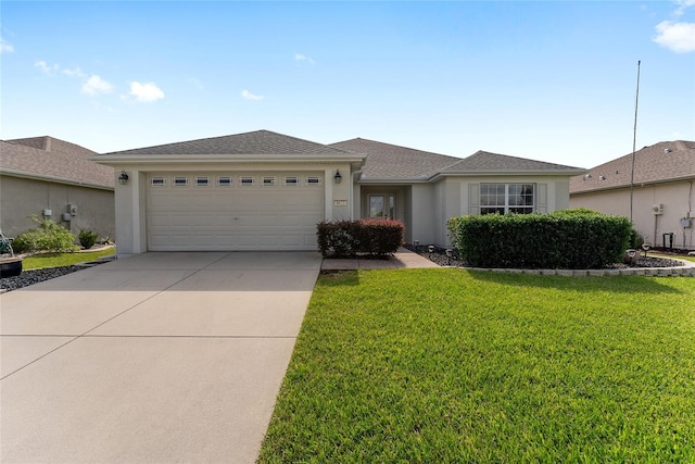 single story home with a front yard and a garage