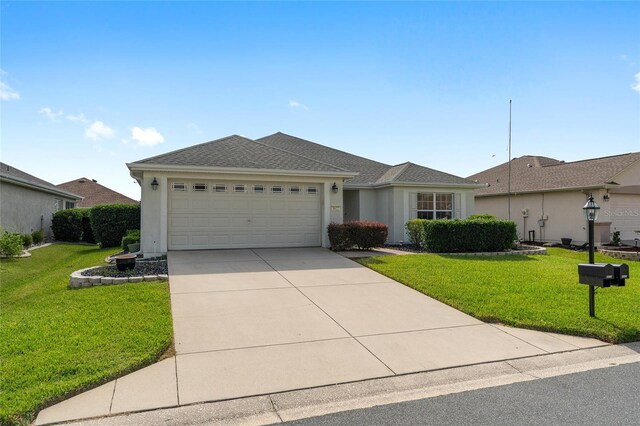 single story home with a front yard and a garage