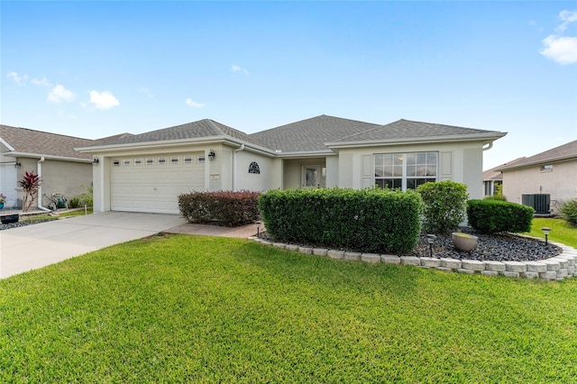 single story home with a front lawn, central AC unit, and a garage