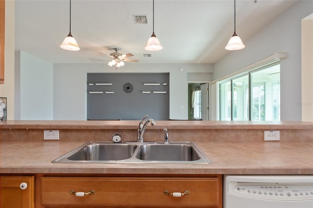 kitchen with dishwasher, sink, pendant lighting, a textured ceiling, and ceiling fan