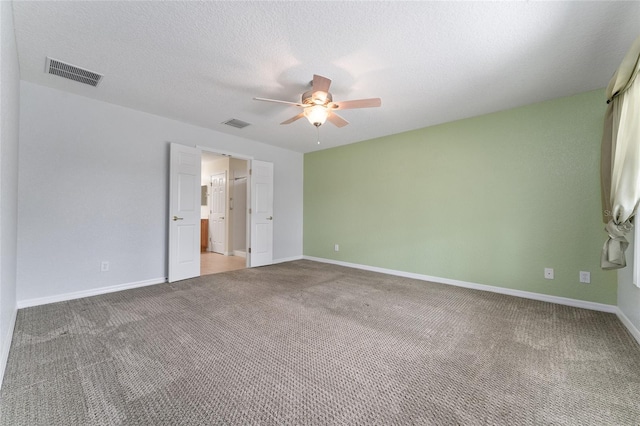 unfurnished bedroom with ceiling fan, carpet flooring, and a textured ceiling