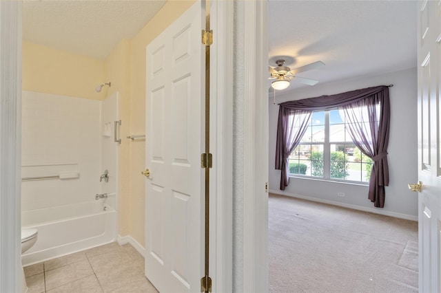 bathroom with toilet, tile patterned flooring, bathtub / shower combination, a textured ceiling, and ceiling fan