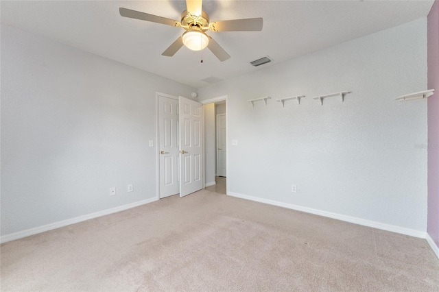 unfurnished room with light carpet and ceiling fan