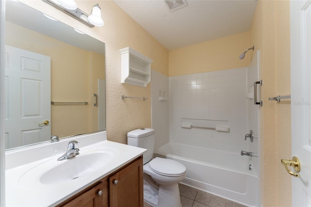 full bathroom with a textured ceiling, toilet, vanity, washtub / shower combination, and tile patterned flooring