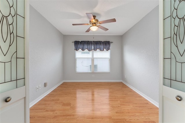 spare room featuring light hardwood / wood-style flooring and ceiling fan