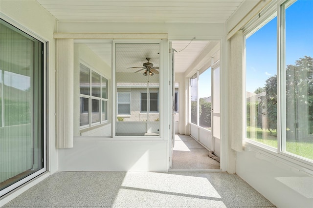 unfurnished sunroom with ceiling fan and a wealth of natural light