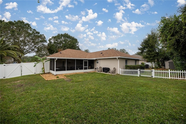 back of property with a sunroom and a yard