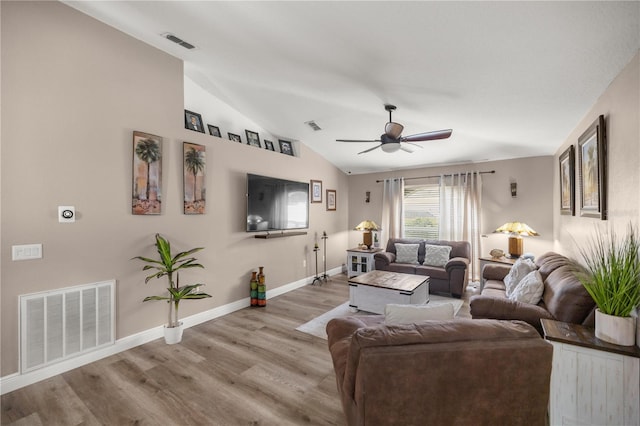 living room featuring ceiling fan, light hardwood / wood-style flooring, and vaulted ceiling