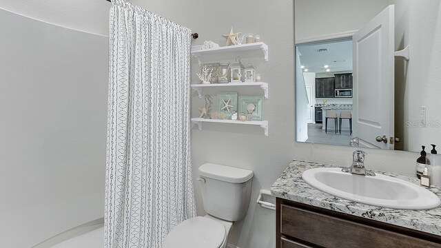 bathroom with vanity, toilet, and a shower with curtain