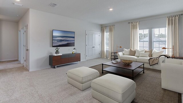 carpeted living room with visible vents and baseboards