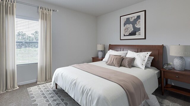 bedroom featuring light carpet, multiple windows, and baseboards