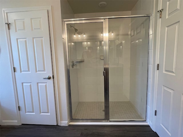 bathroom with wood-type flooring and walk in shower