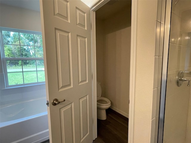 bathroom featuring separate shower and tub, hardwood / wood-style floors, and toilet