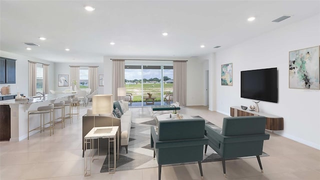 living area featuring recessed lighting, visible vents, and baseboards