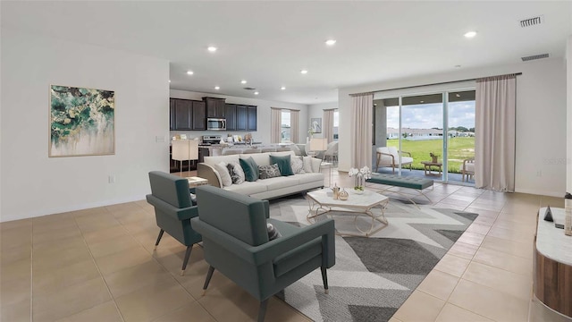 living area featuring recessed lighting, visible vents, baseboards, and light tile patterned floors