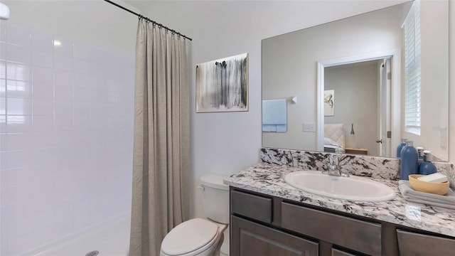 full bath with vanity, a shower with shower curtain, connected bathroom, and toilet