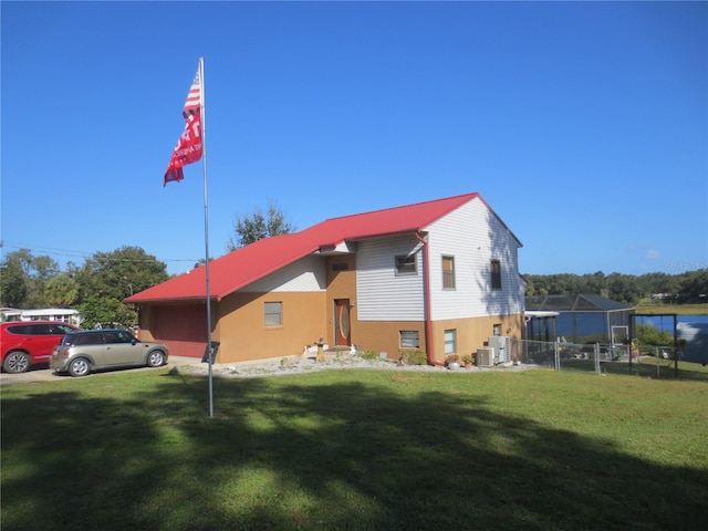 exterior space featuring a yard and central air condition unit