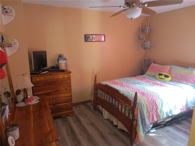 bedroom featuring dark hardwood / wood-style flooring and ceiling fan