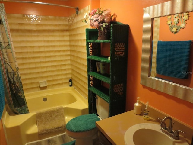 full bathroom with vanity, shower / bath combo with shower curtain, and toilet