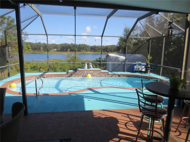 view of swimming pool with a jacuzzi, a water view, pool water feature, a lanai, and a patio