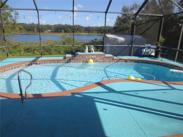 view of swimming pool featuring a water view, pool water feature, a lanai, and a patio