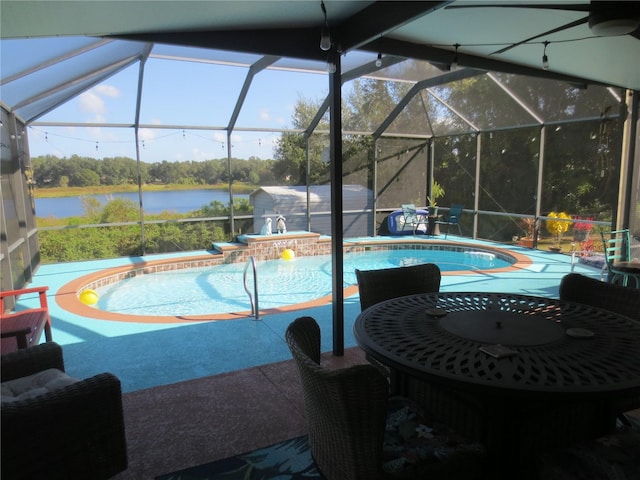 view of swimming pool featuring a patio, a hot tub, a water view, and a lanai