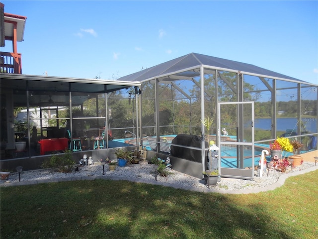 exterior space with a water view and glass enclosure